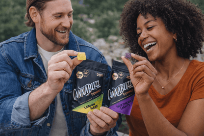 Two people holding and showing off Cannabuzz brand products outdoors.